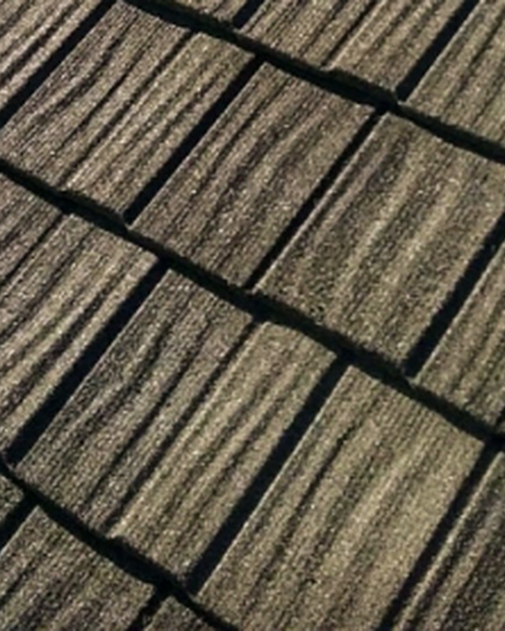 Close-up of DECRA Shake XD stone-coated steel with heavy-cut vertical wood-grain texture