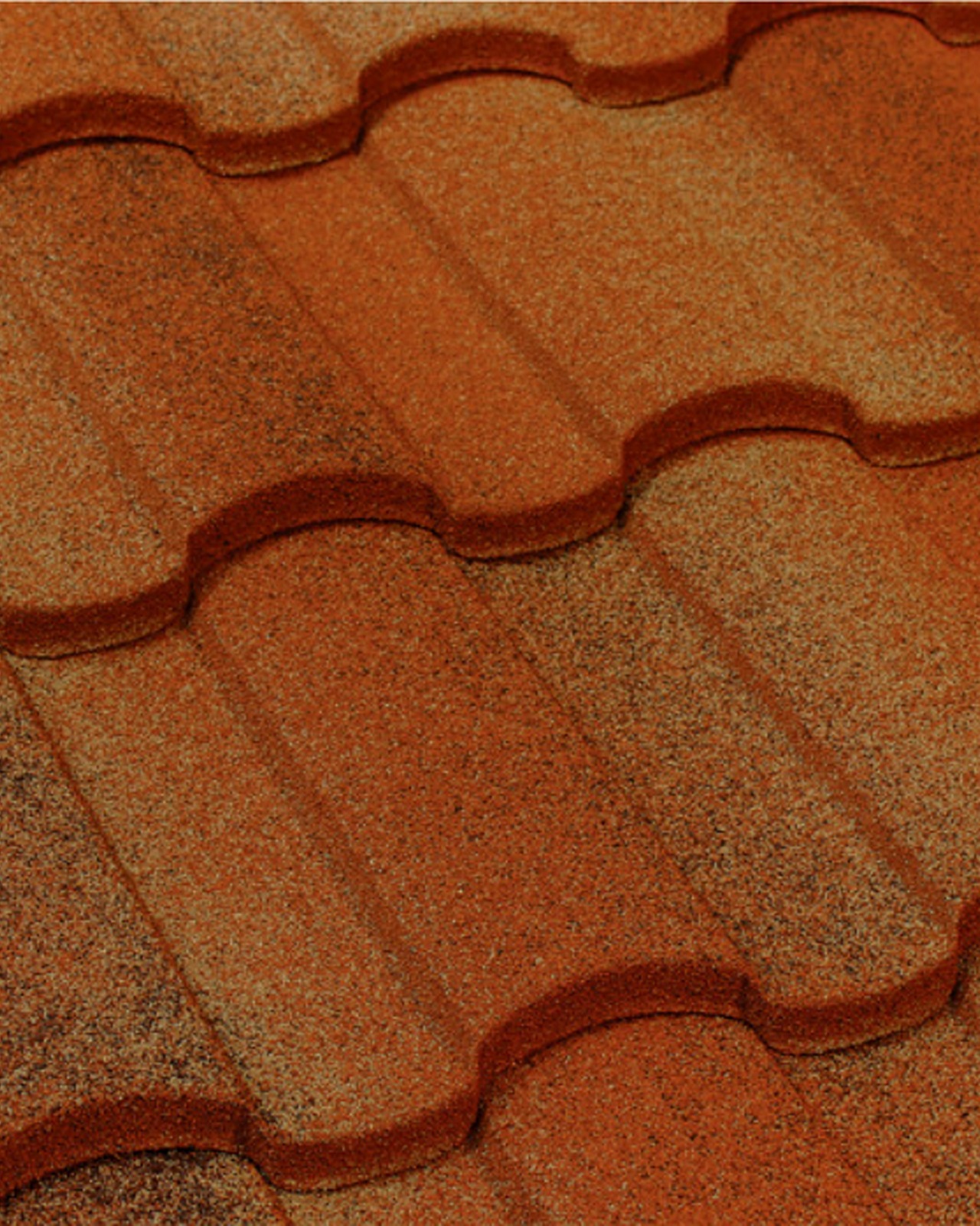 Close-up of Tilcor Antica stone-coated steel roofing in Mediterranean barrel-tile profile