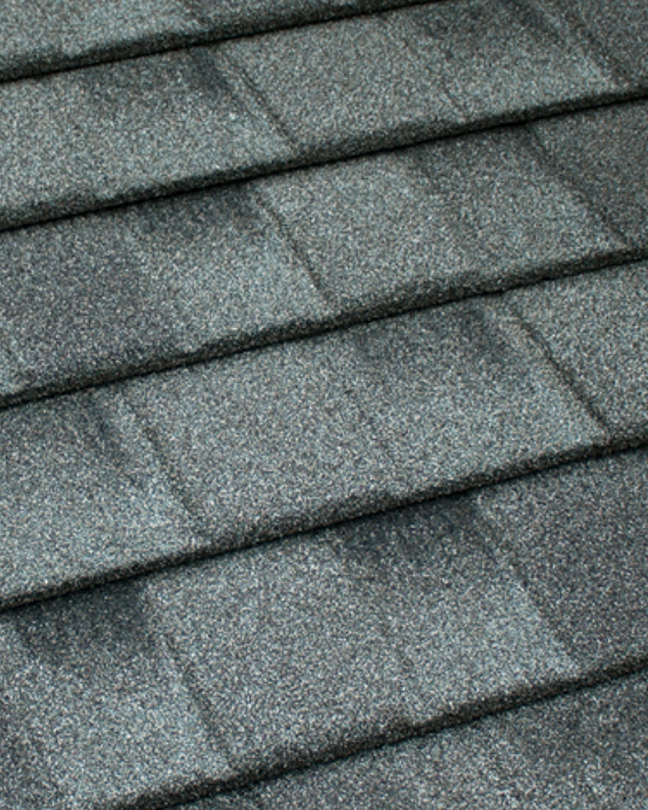 Close-up of Tilcor CF Shingle flat interlocking charcoal stone-coated steel panel with staggered rectangular shingle cuts