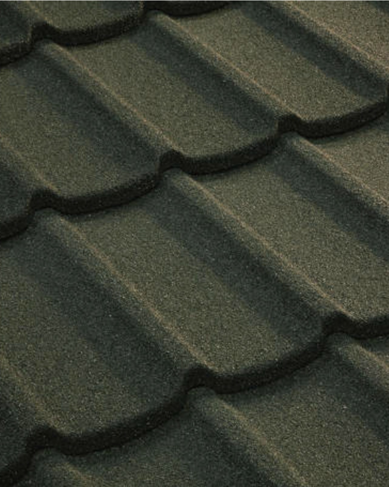 Close-up of Tilcor Tudor stone-coated steel roofing with classic wavy scalloped European shingle profile